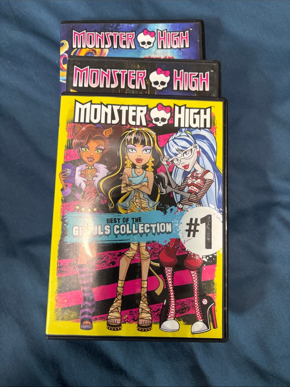 monster high DVD set with bright yellow and pink cover art